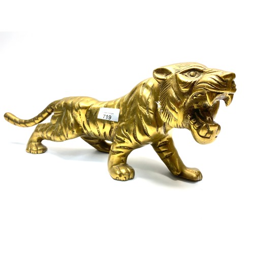 719 - Large brass lion statue 45cm long.