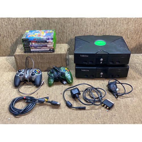 182 - Two original Xbox's with games and controls.