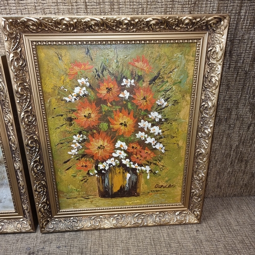 180A - Two oil on board paintings one floral signed Donald and beach scene.