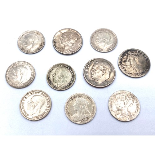 865B - Collection of silver 3 pences and American dimes.