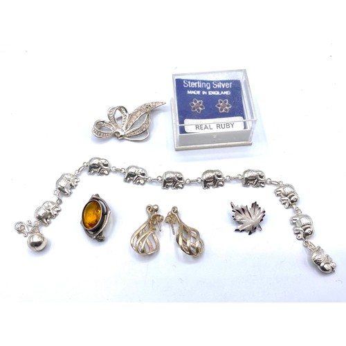 485 - Silver earrings, silver and amber brooch, filigree brooch and maple leaf, and elephant bracelet.