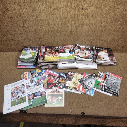 457 - A quantity of football programmes and magazines mostly Swansea FC programmes some signed.