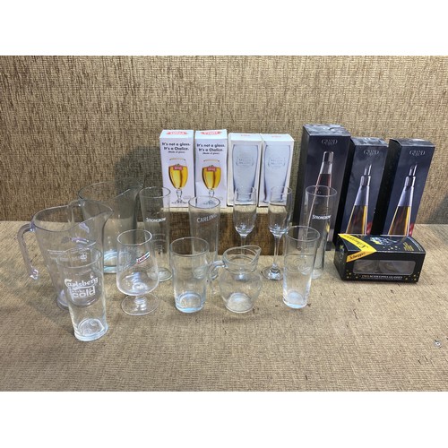 64 - Collection of alcohol advertising glasses and jugs including Stella and Schweppes, some boxed.