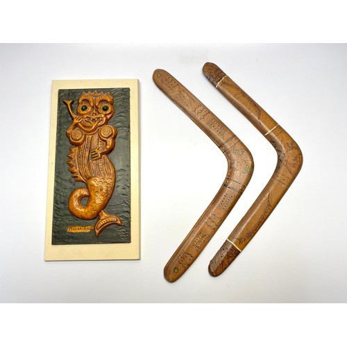 463 - Two vintage wooden boomerangs and a mythical plaque of the Marikina monster.