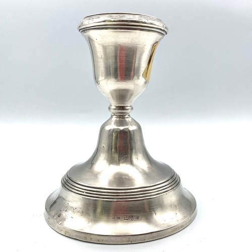 853 - Stirling silver candle stick. 11cm with metal base. Chester 1922. By Jones & Crompton with age relat... 