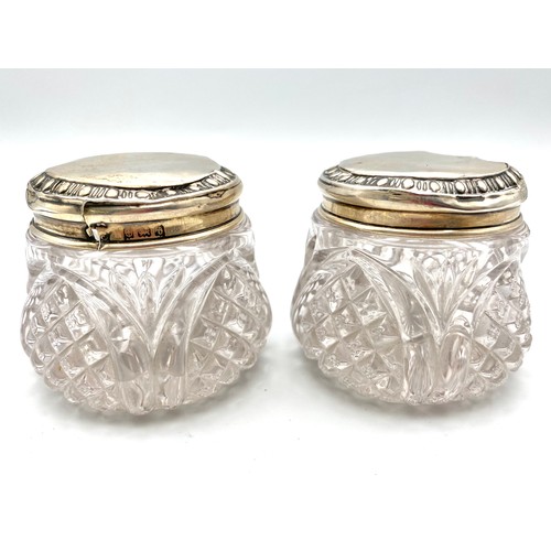 858 - Two cut Crystal sterling silver topped vanity jars 5cm Birmingham 1918 with with age related charm a... 