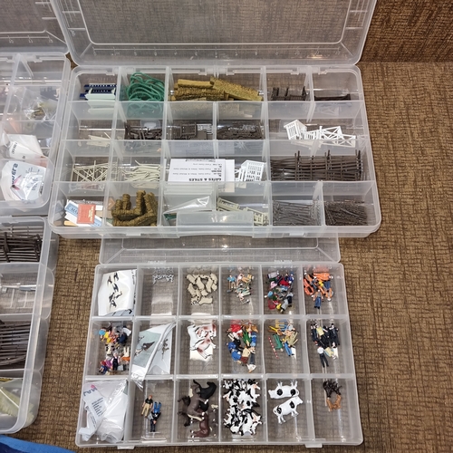 1108 - Selection of plastic storage containers full of model railway scenery.