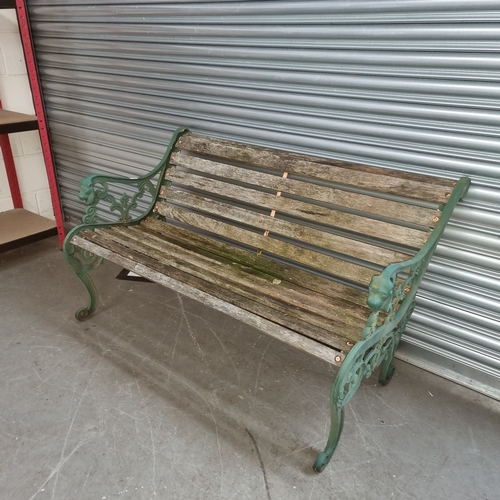 136 - Wooden and cast iron garden bench.