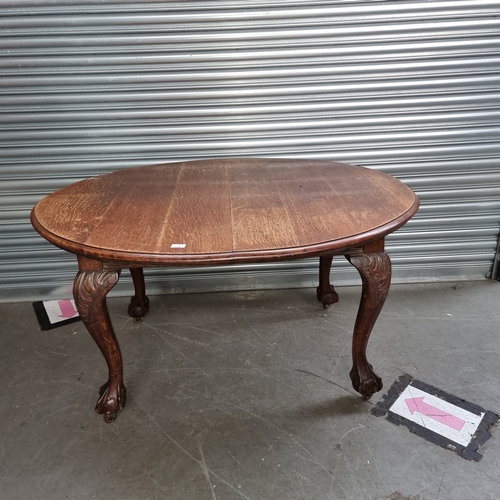 138 - Oak late Victorian dining table with claw feet and original casters.