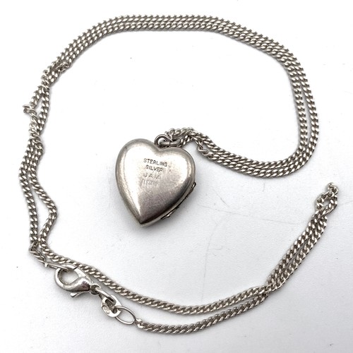 876 - Stirling sliver heart locket and silver chain.