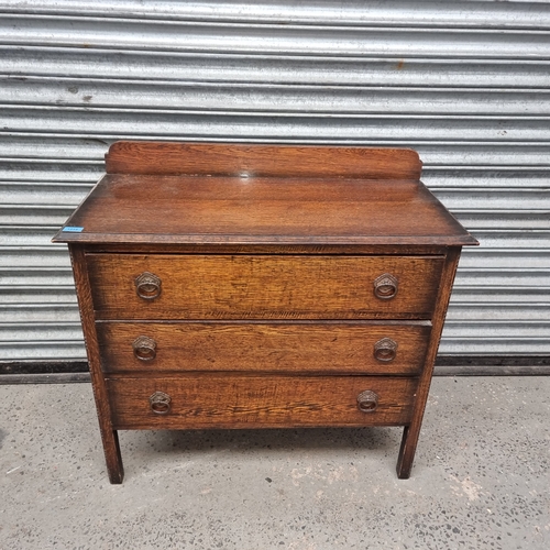 1214 - Solid oak three drawer chest of drawers.