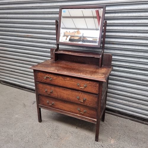 1215 - Oak dressing table with three drawers and bevelled mirror.