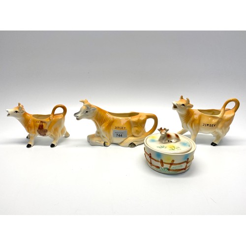 744 - Three ceramic Jersey creamers and a ceramic Jersey butter dish.