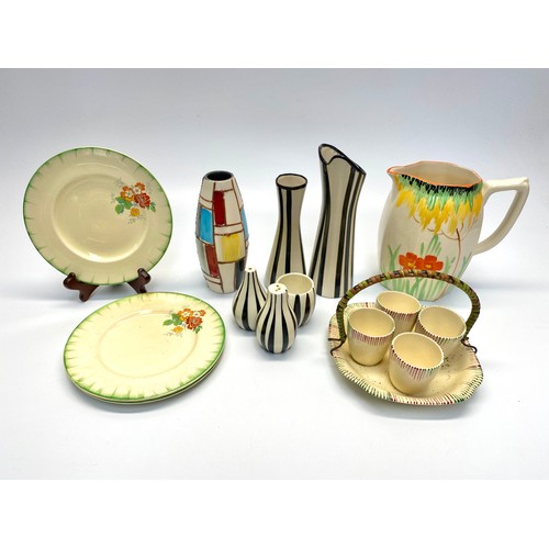 764 - Colourful ceramics including: 3 Claris cliff cake plates and Wade Heath hand painted jug.