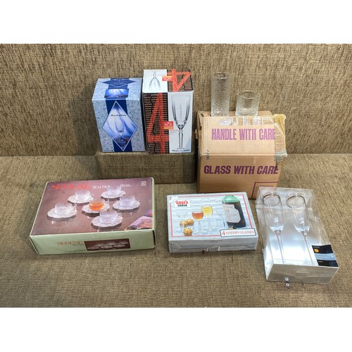 68 - Selection of retail boxed glasses including: champagne flutes and serene glass tea set.