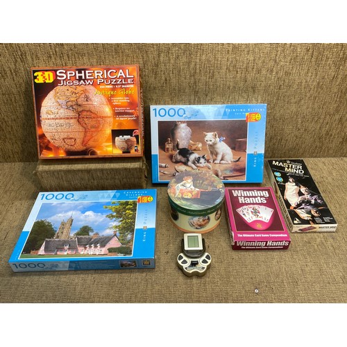 130 - Large selection of games and puzzles including: 3D spherical puzzle and a retro super block game.