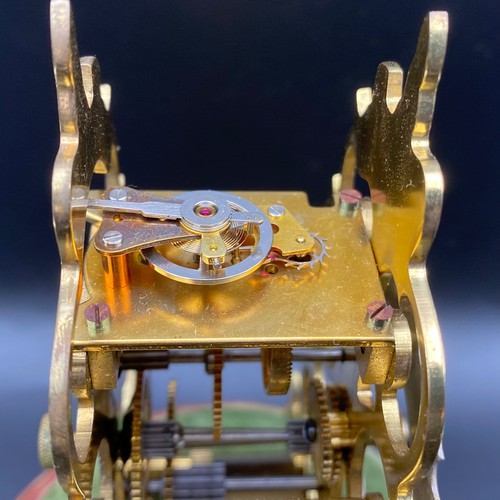 722 - Hand etched victorian style brass skeleton clock in glass case and marble base. Key included. 19cm.