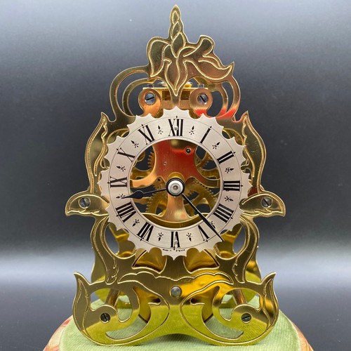 722 - Hand etched victorian style brass skeleton clock in glass case and marble base. Key included. 19cm.