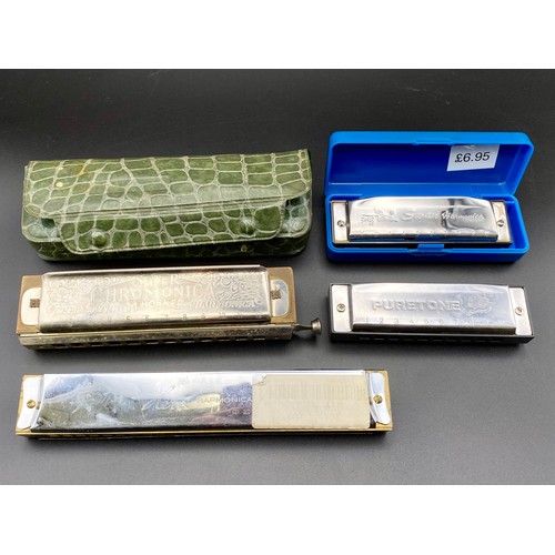 733 - Four vintage harmonicas including The Super Chromonica by M.Hohner.