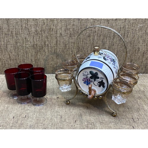 496 - ceramic spanish shot dispenser + shot glasses and four cherry red shot glasses.