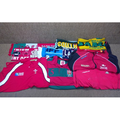 510 - Selection of sportwear including: Welsh rugby shirts and team scarves.