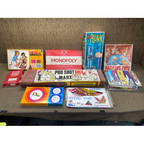 1267 - Large selection of boxed vintage games including etch a sketch , monopoly and battling tops.