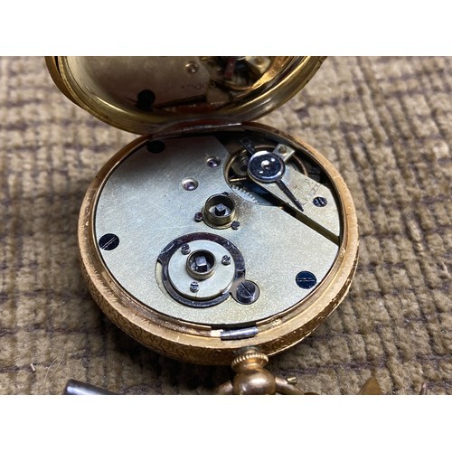 897 - 18ct gold ladies pocket watch 33.5g with movement, 4.5cm (working) with one key and fob bow.