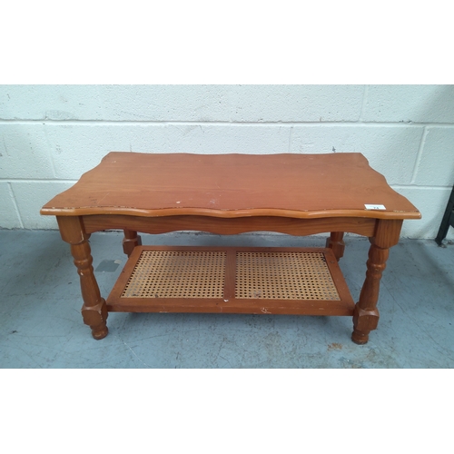 74 - Small pine coffee table with wicker base.