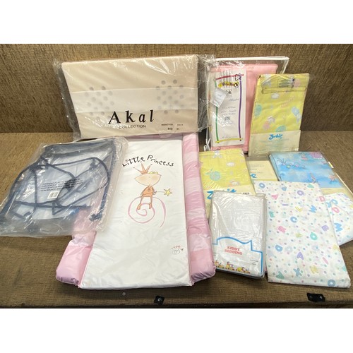 94 - Retail packaged children's bedding and curtains and a baby changing mat.