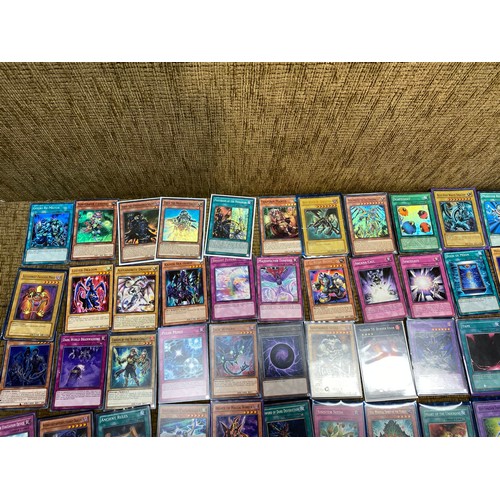 732 - Approximately 100 yu-gi-ho trading cards including an range of different rarity of cards.