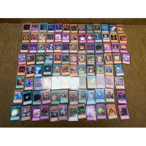 732 - Approximately 100 yu-gi-ho trading cards including an range of different rarity of cards.