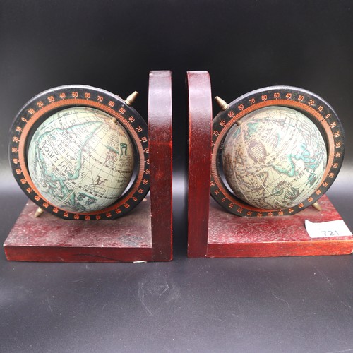 721 - Two globe book ends. 15cm tall.