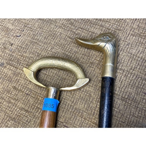 1085 - 2 brass top vintage walking canes. One has been hand craved.