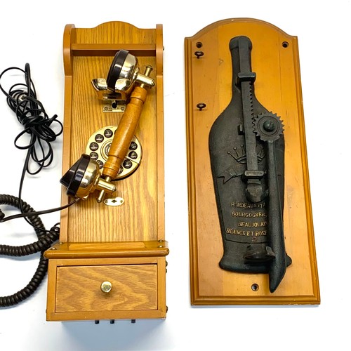 1129 - 2 wall mounted collectibles including: cast iron glass bottle opener and vintage style phone