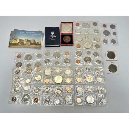 773 - 12 sets of  Canadian uncirculated coin sets and paperwork, and other coins.