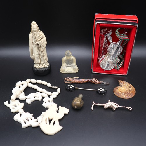 785 - Carved bone figures, tie pins and collectibles.