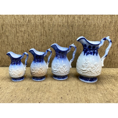 530 - A set of four graduated glazed pottery jugs.