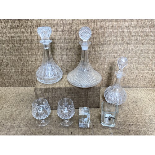 539 - three cut glass decanters and glasses.