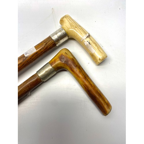 657 - 2 vintage walking canes with antler and bone handles with white metal rim fittings.