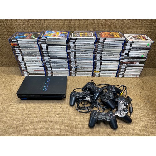 1050 - Large selection of PS2 games and console and controllers.