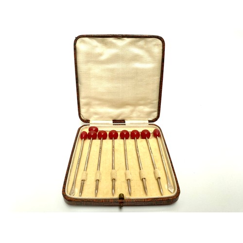 851 - Set of six  cased cherry sterling silver cocktail sticks, and three bean  sterling silver sticks. Bi... 