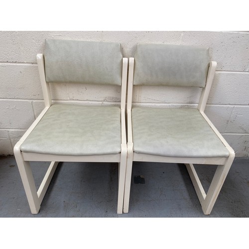 105 - 2 white modern dining chairs.