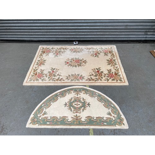 137 - Large cream vintage floor rug and a smaller half moon rugs. Largest: 6ft x 4ft and smallest: 130cm x... 