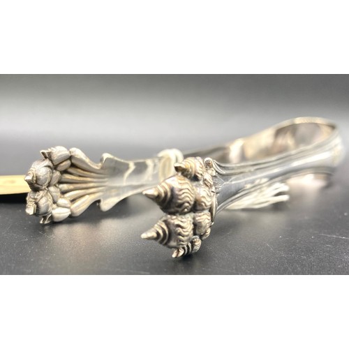 913 - White metal lions claw sugar tongs, faded hallmarks to the shoulders possibly early American (Charle... 