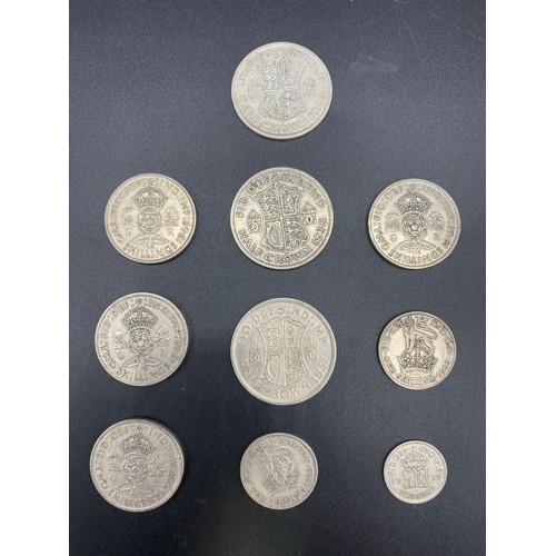 920 - 10 Half silver British coins including Half Crowns and two shillings. 101g.