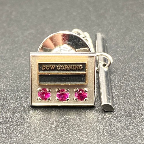 922 - Dow Corning 10k gold fronted tie pin with three rubies.