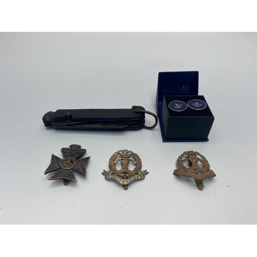 744 - Jack knife, three cap badges and a set of Naval cufflinks.