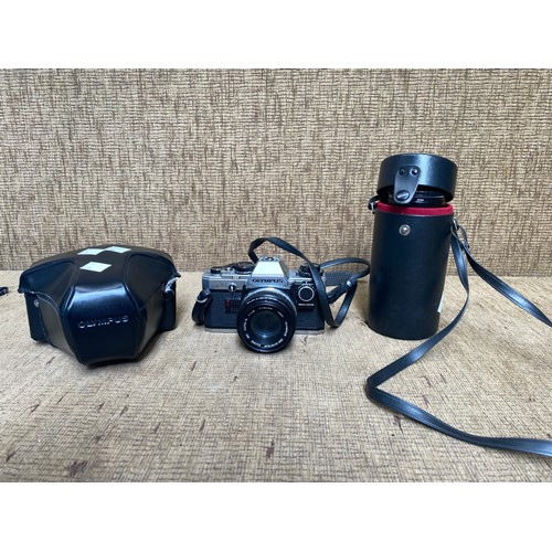 753 - Olympus camera with additional lens and case.