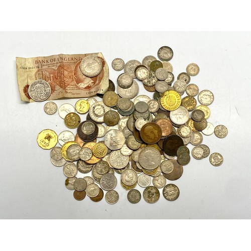 936 - Coins in an OXO tin, including a 10 Shilling note.