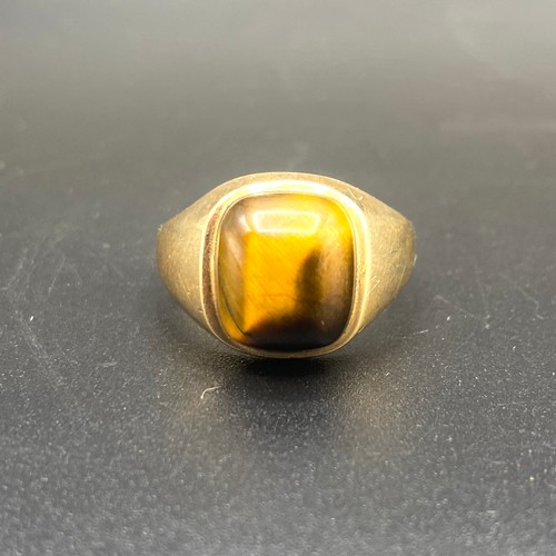 864 - 9ct gold tigers eye ring. 5g size R.